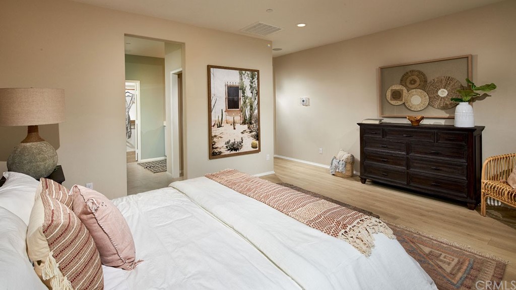 44431 Beringer Drive Indio, CA 92203 - Photo 11 of 17 a bedroom with a bed and a painting on the wall