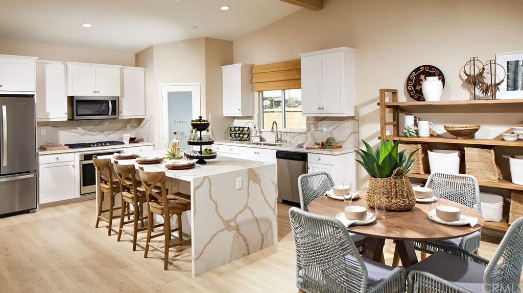 44431 Beringer Drive Indio, CA 92203 - Photo 6 of 17 a kitchen with a dining table cabinets and appliances