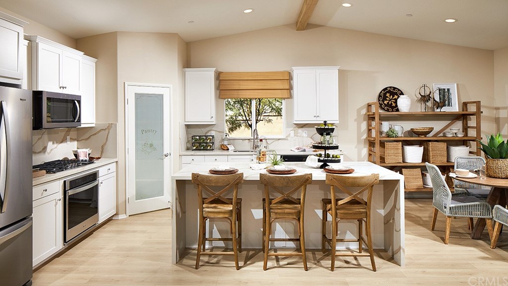 44431 Beringer Drive Indio, CA 92203 - Photo 7 of 17 a dining hall with stainless steel appliances kitchen island granite countertop a dining table and chairs