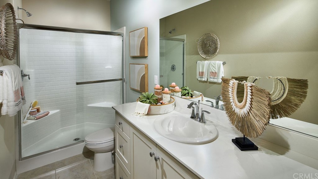 44431 Beringer Drive Indio, CA 92203 - Photo 9 of 17 a bathroom with a granite countertop sink a toilet and shower