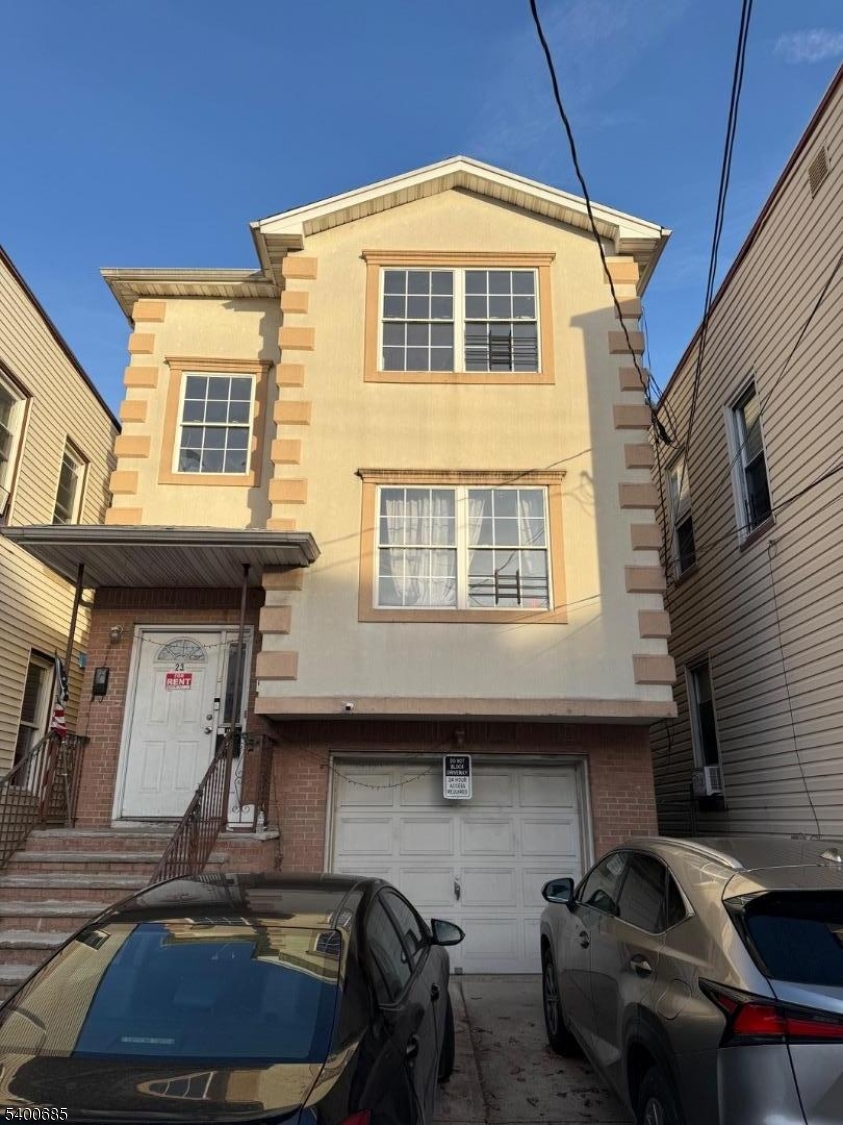 a front view of a house with many windows