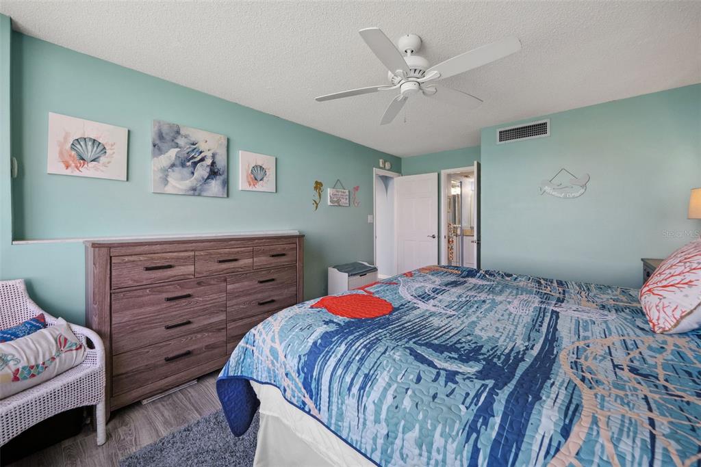 5151 Isla Key Boulevard South, Unit 421 St. Petersburg, FL 33715 - Photo 27 of 61 a bedroom with a bed and a chandelier