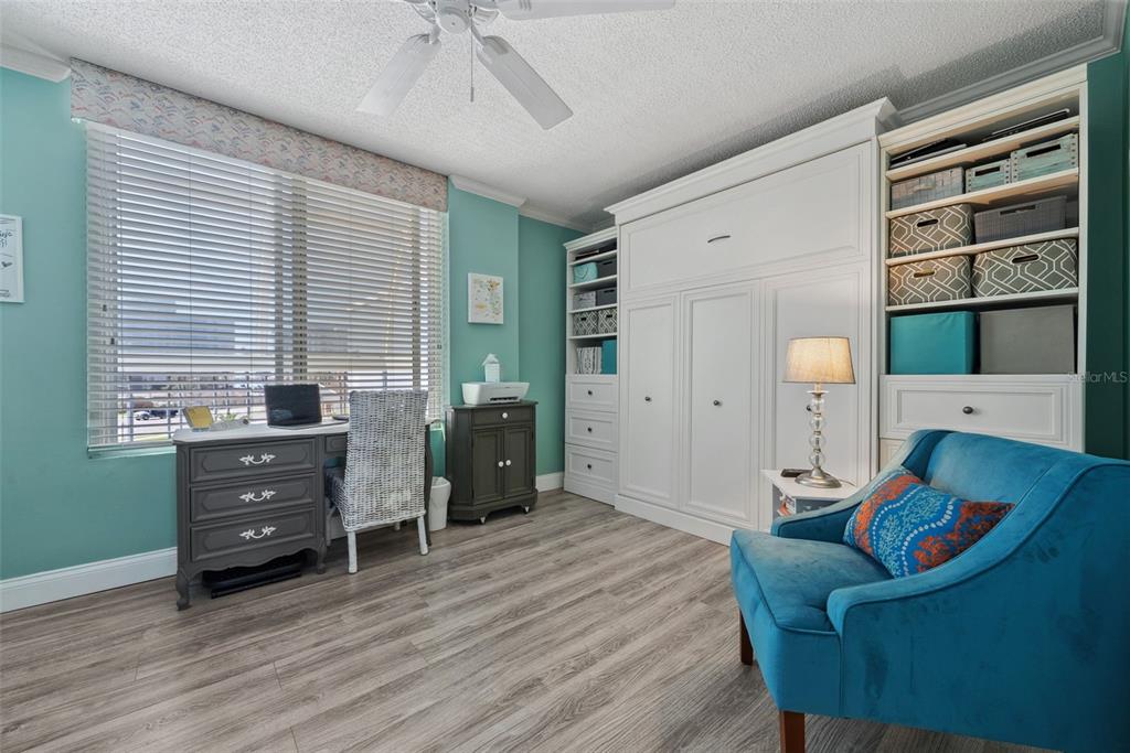 5151 Isla Key Boulevard South, Unit 421 St. Petersburg, FL 33715 - Photo 32 of 61 a living room with furniture and a flat screen tv