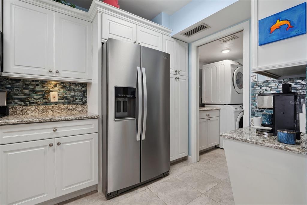 5151 Isla Key Boulevard South, Unit 421 St. Petersburg, FL 33715 - Photo 10 of 61 a kitchen with stainless steel appliances granite countertop a refrigerator and a sink