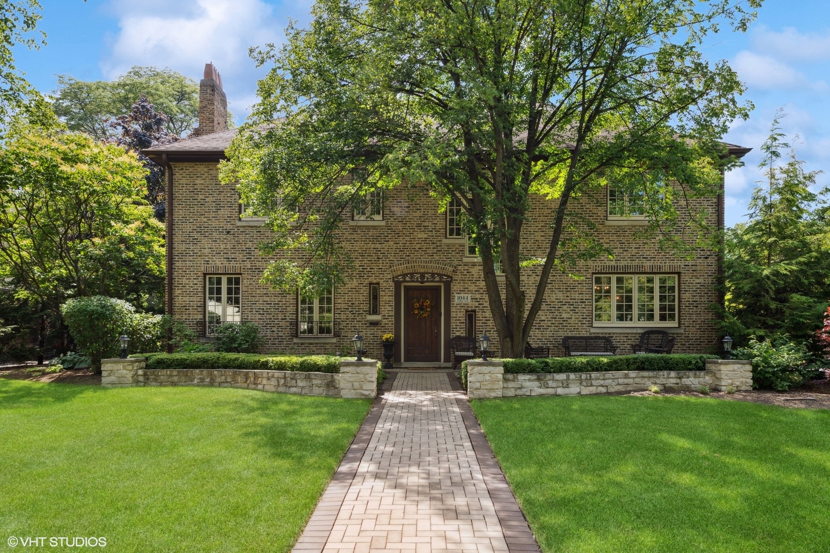 a front view of a house with garden