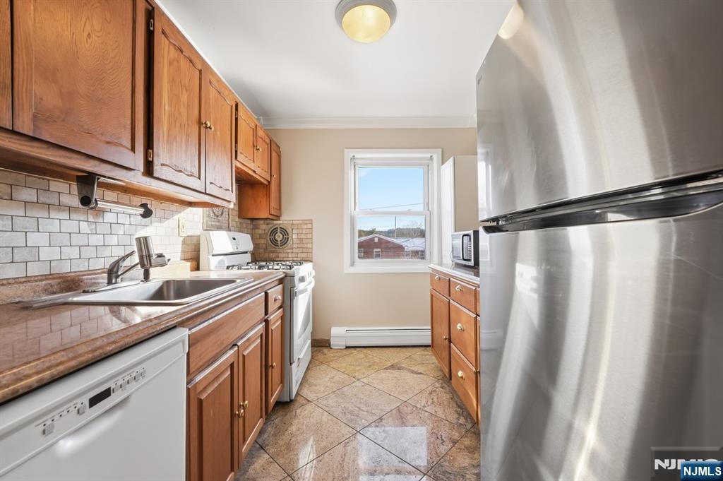 28 Knox Terrace Wayne, NJ 07470 - Photo 6 of 15 a kitchen with a sink a refrigerator and cabinets