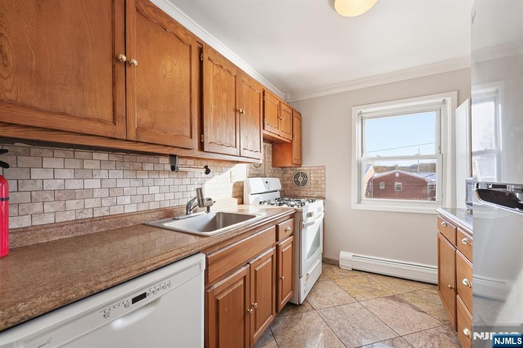 28 Knox Terrace Wayne, NJ 07470 - Photo 7 of 15 a kitchen with stainless steel appliances granite countertop a sink stove and cabinets