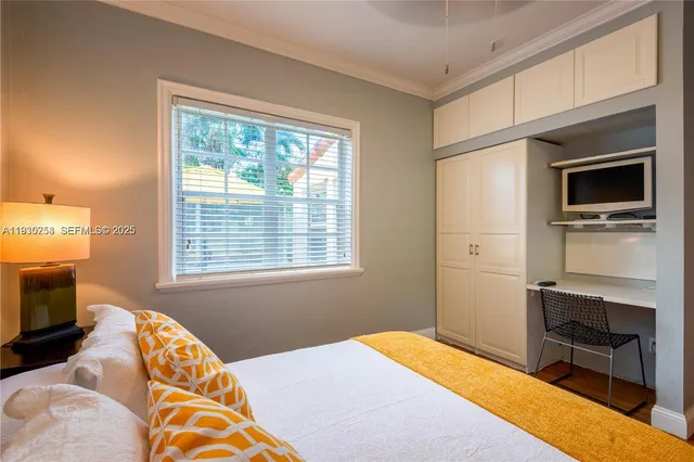 a bedroom with a bed and a television