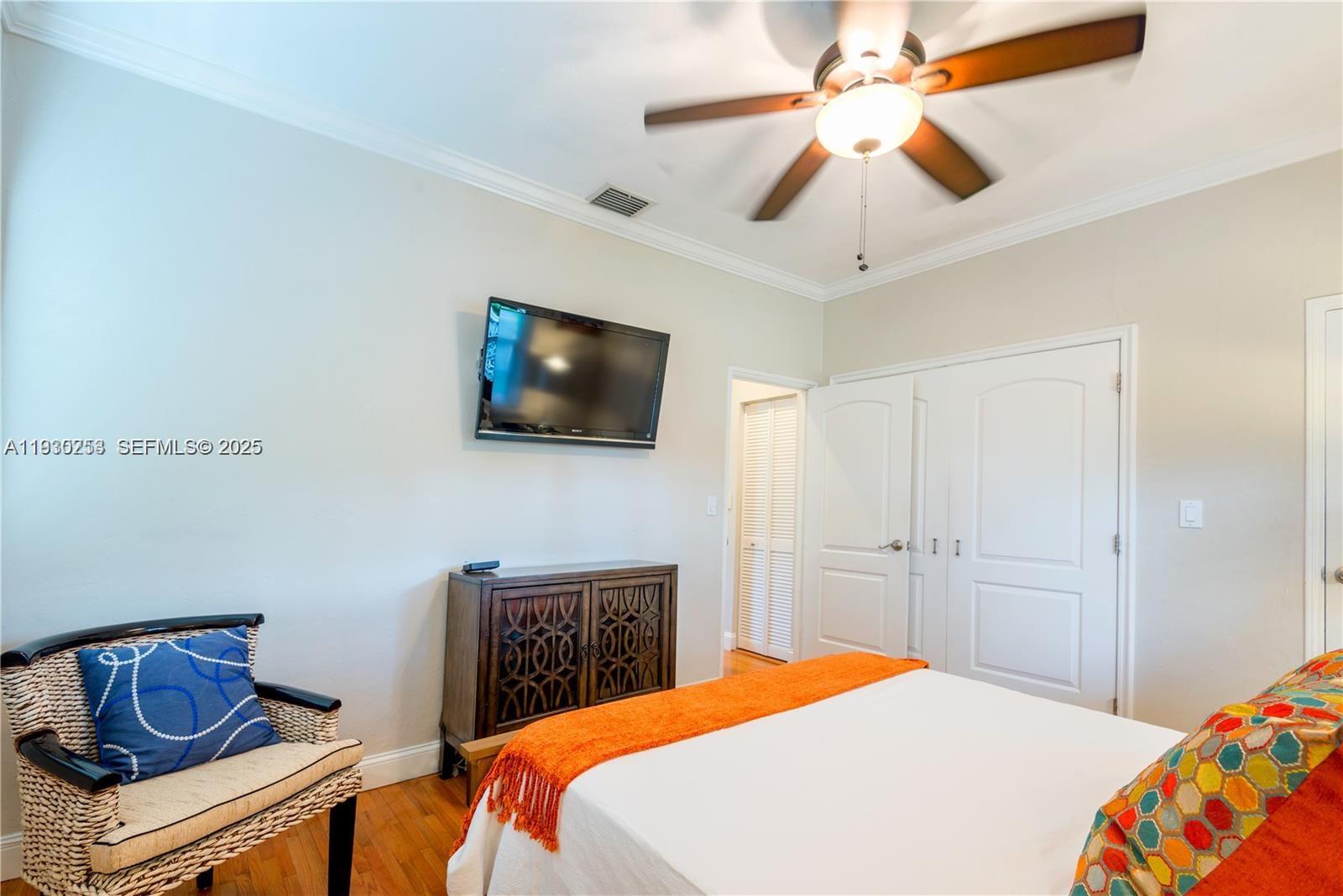 2308 Southwest 23rd Terrace Miami, FL 33145 - Photo 14 of 27 a bedroom with a bed and a flat screen tv