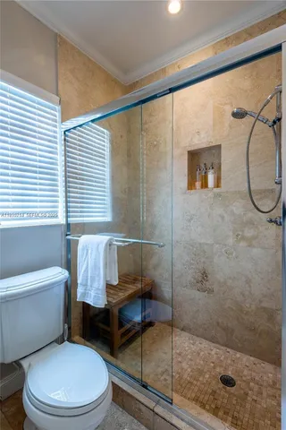 a bathroom with a toilet and a shower
