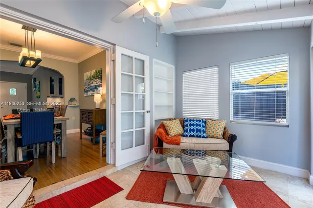 a living room with furniture and a dining table with wooden floor