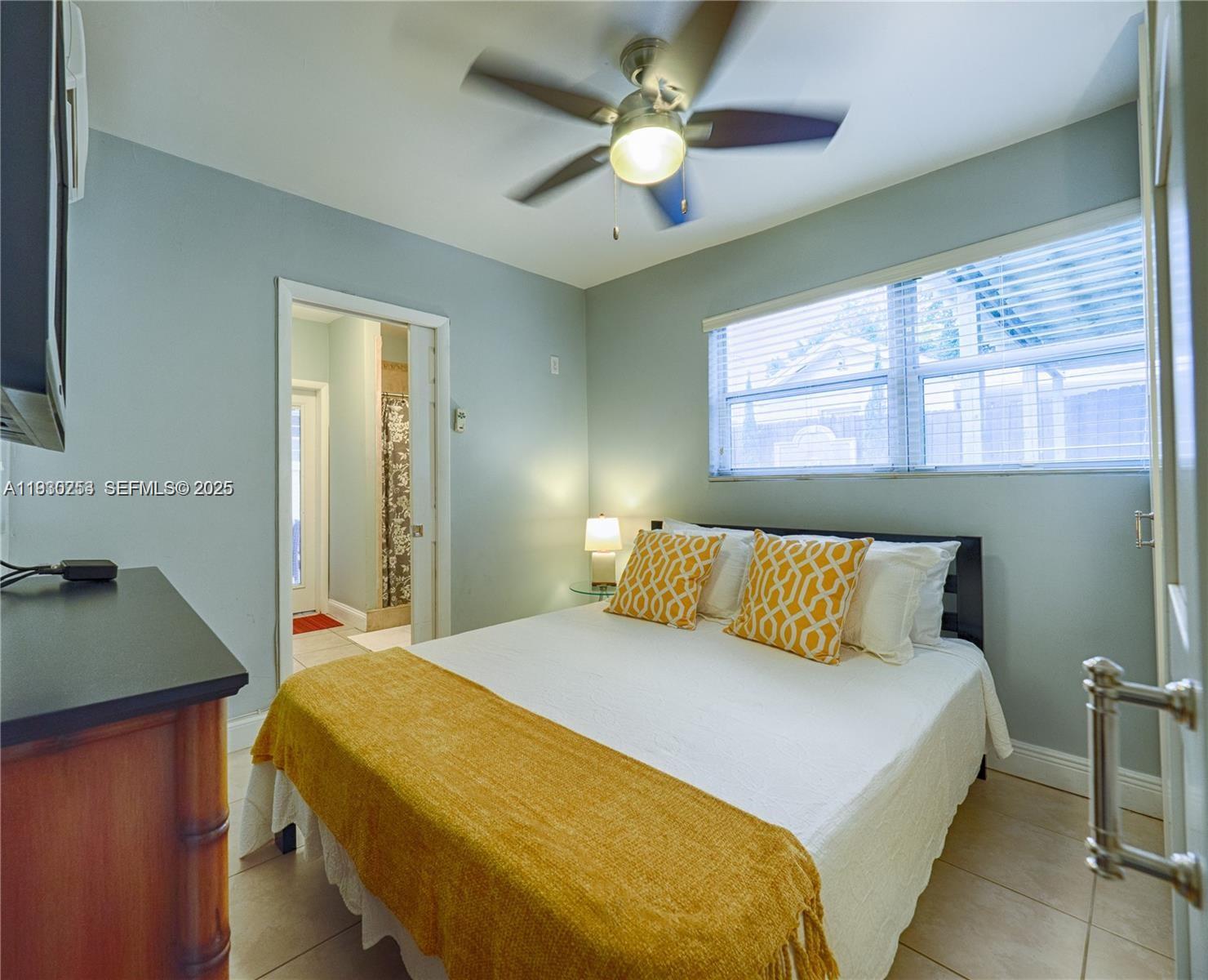 2308 Southwest 23rd Terrace Miami, FL 33145 - Photo 21 of 27 a bedroom with a bed and a chandelier