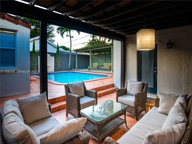 a outdoor living space with patio furniture and a potted plants