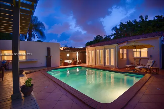 a view of a swimming pool with outdoor seating