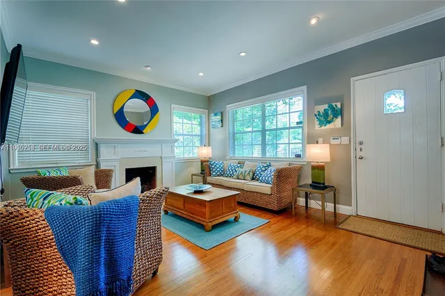 a living room with fireplace furniture and a fireplace