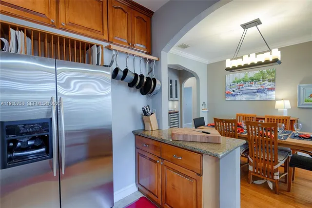 a kitchen with stainless steel appliances granite countertop a sink a stove and a refrigerator