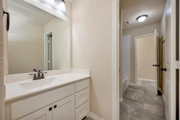 a bedroom with a bed and a ceiling fan