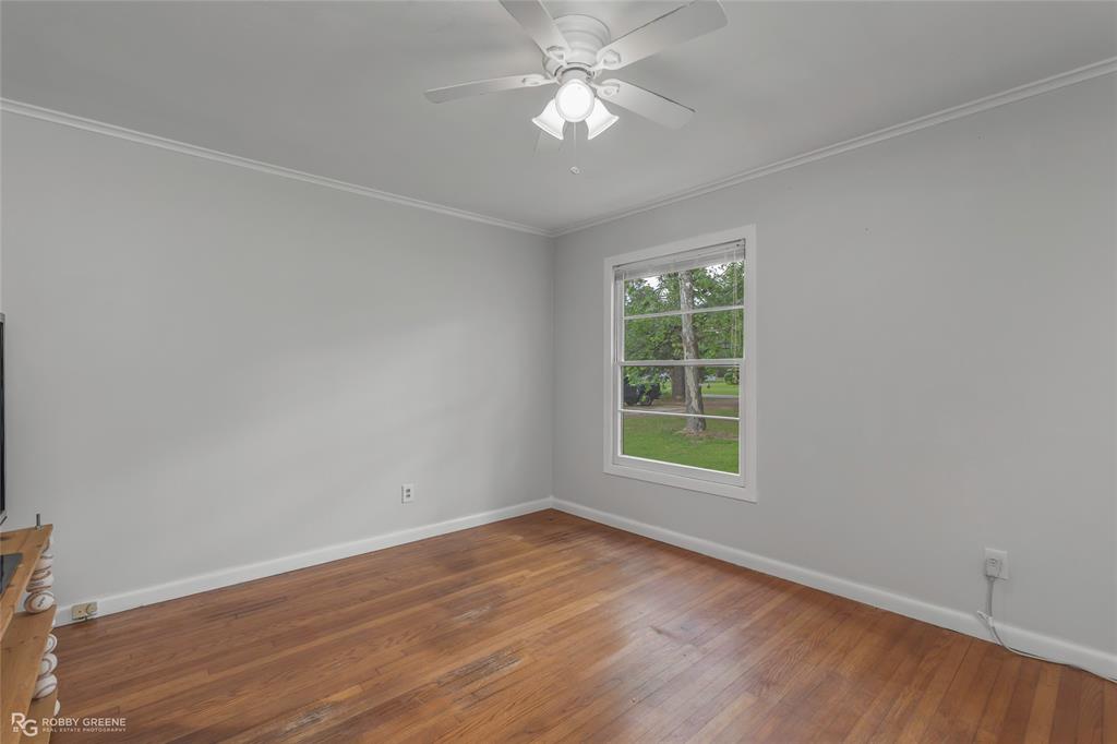5725 Harper Road Keithville, LA 71047 - Photo 11 of 35 wooden floor in an empty room with a window