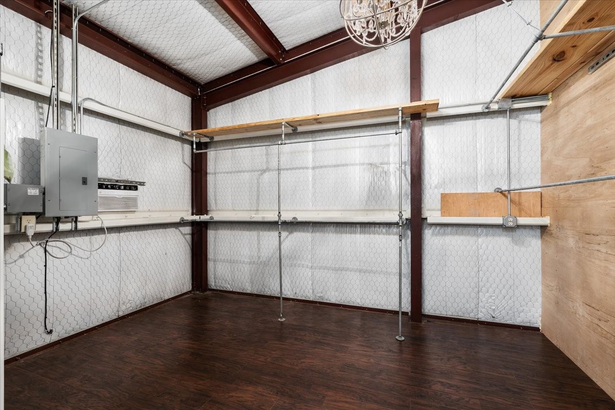 16375 Grand Flower Road Plantersville, TX 77363 - Photo 13 of 50 a view of walk in closet with wooden floor