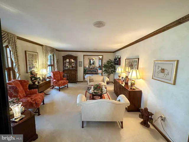 a living room with furniture fireplace and a large window