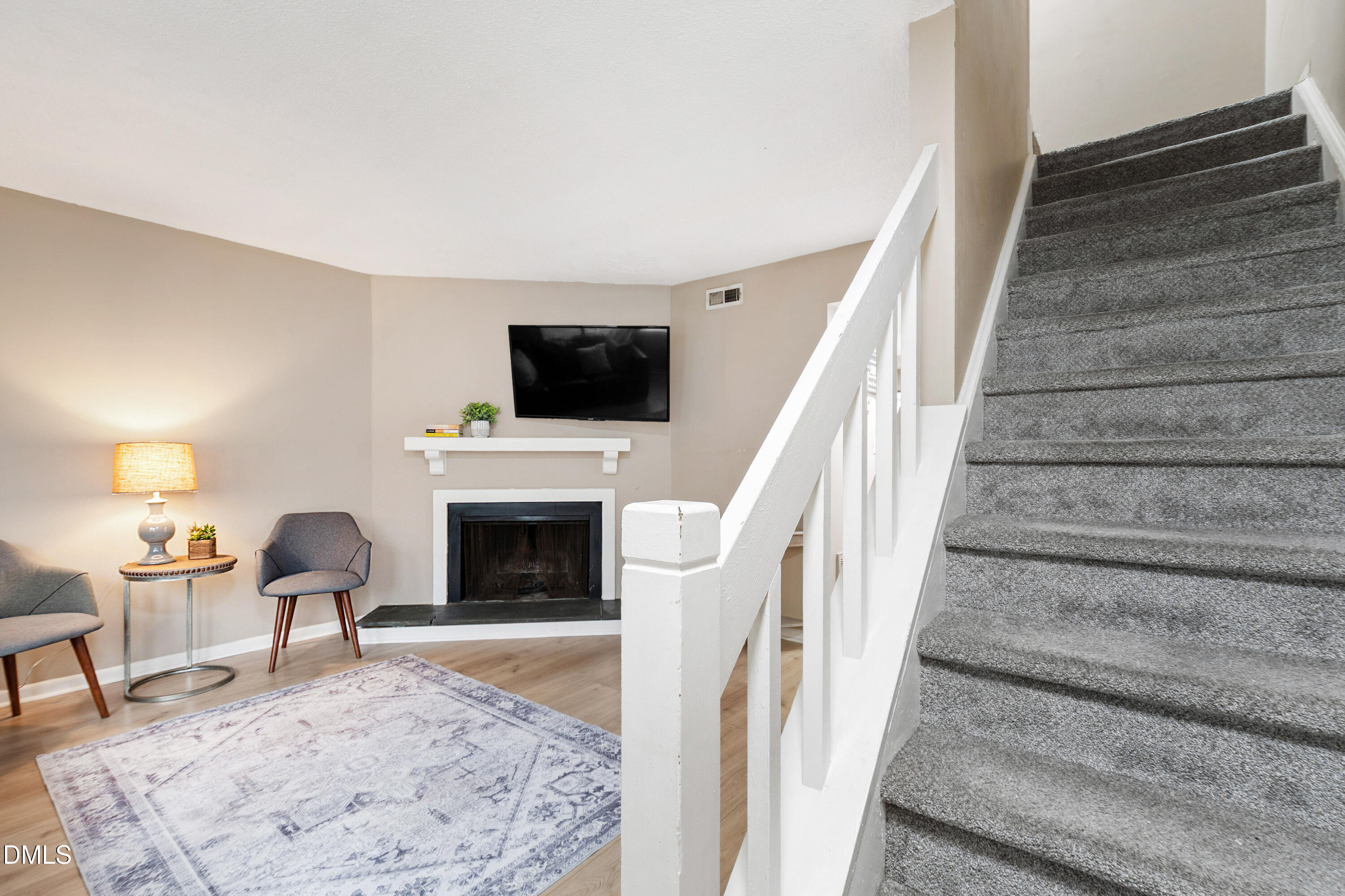 5810 Shady Grove Circle Raleigh, NC 27609 - Photo 13 of 21 a living room with furniture a fireplace and a flat screen tv