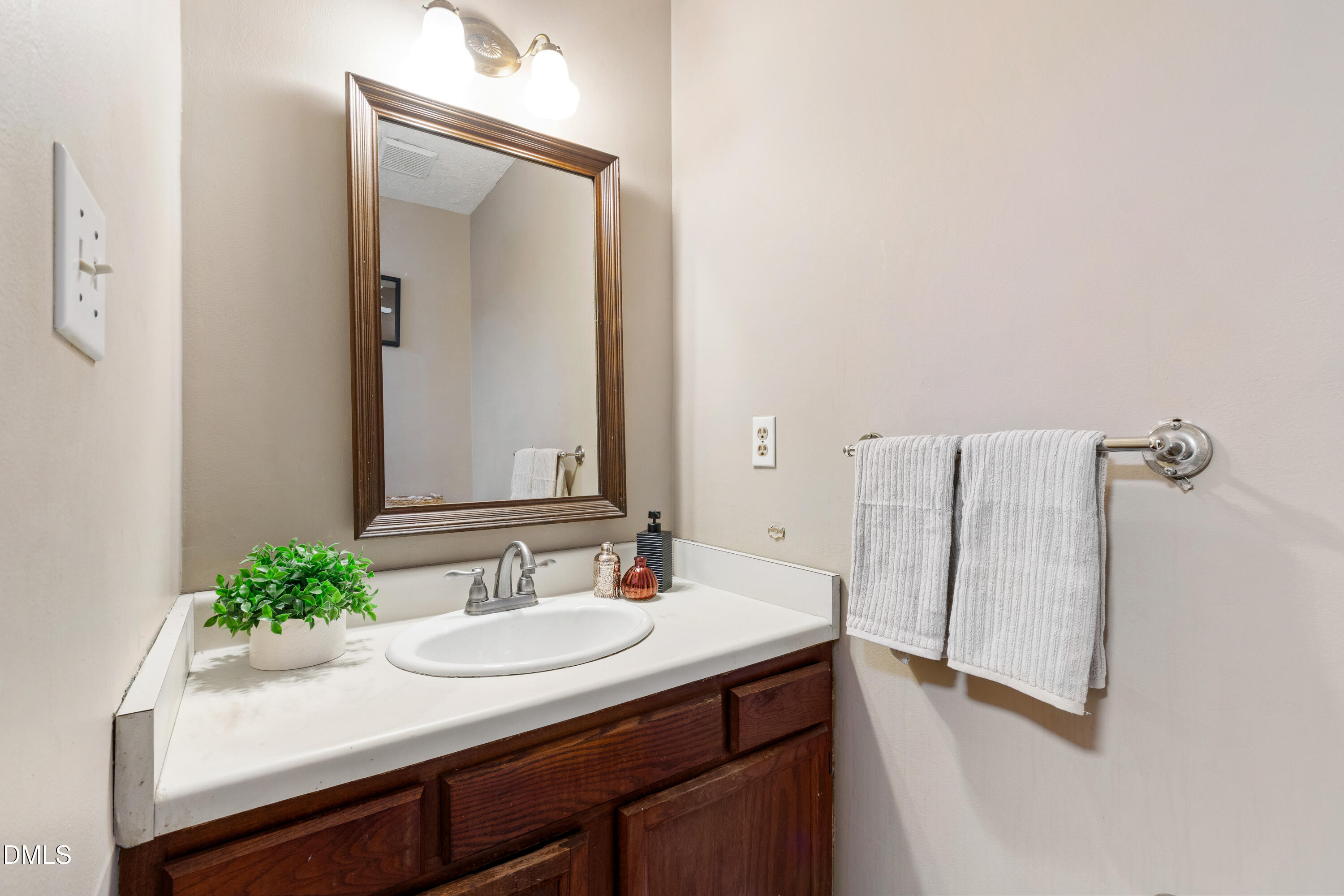 5810 Shady Grove Circle Raleigh, NC 27609 - Photo 14 of 21 a bathroom with a sink and a mirror