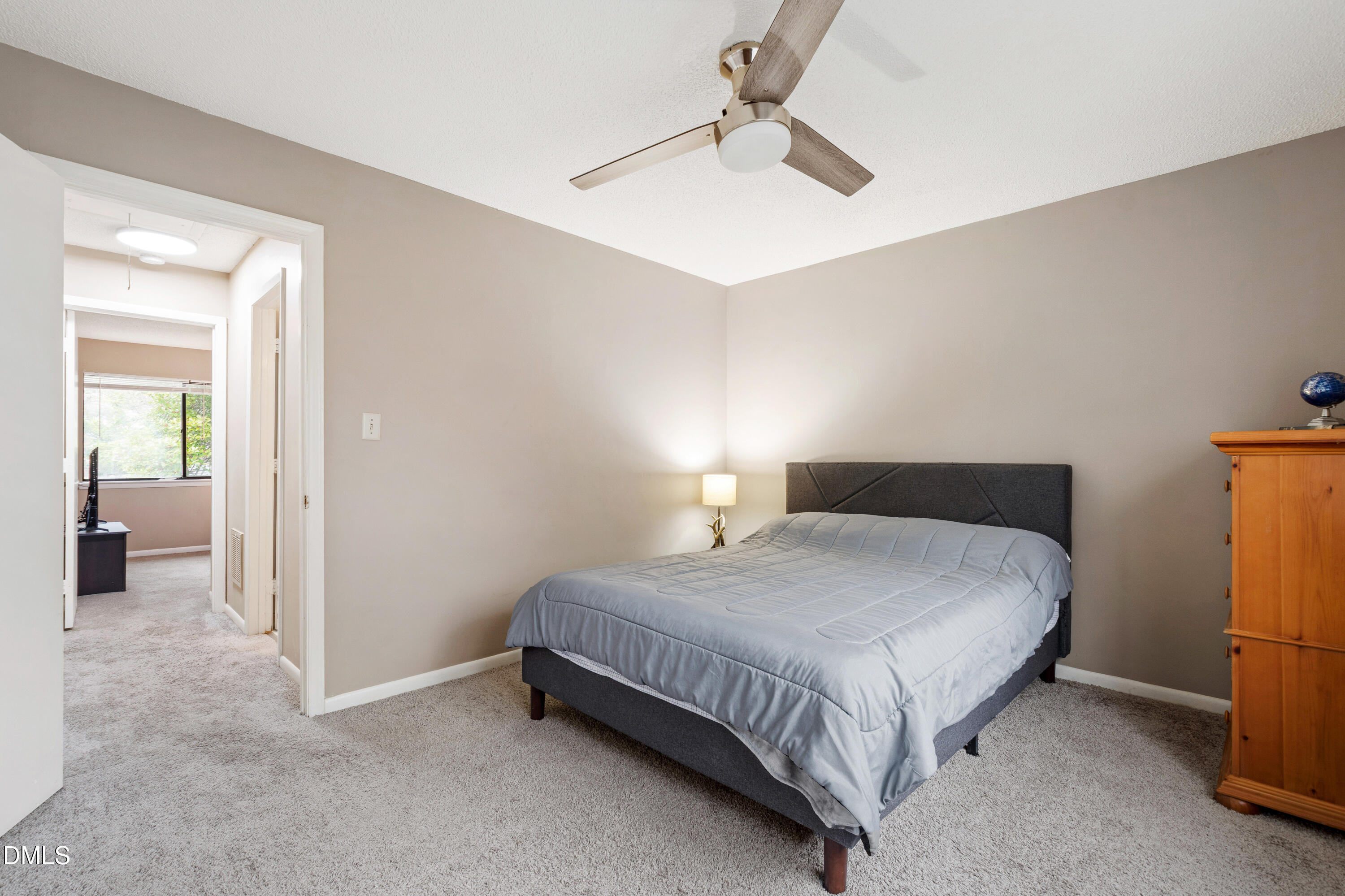 5810 Shady Grove Circle Raleigh, NC 27609 - Photo 4 of 21 a bedroom with a bed and a chandelier