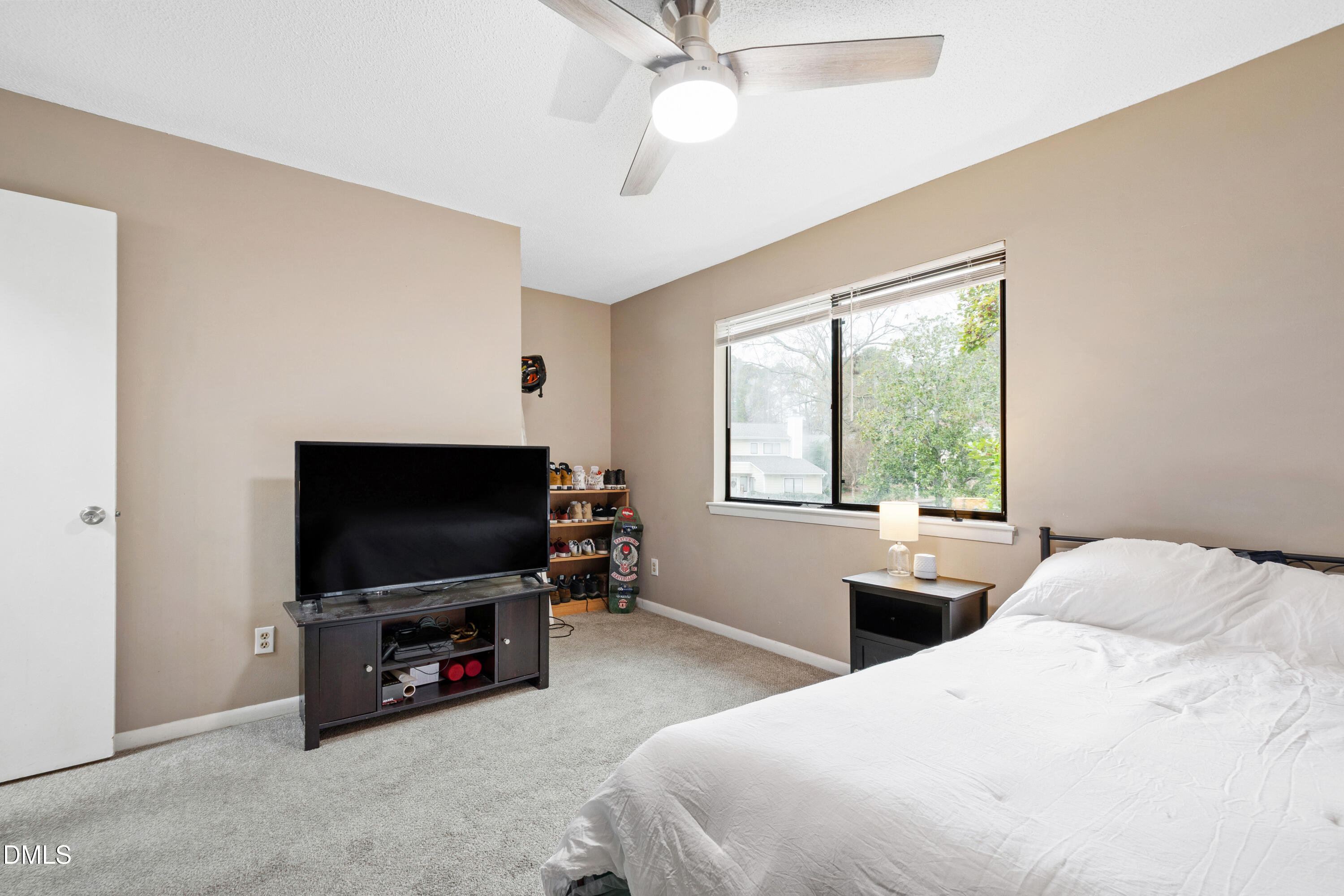 5810 Shady Grove Circle Raleigh, NC 27609 - Photo 6 of 21 a bedroom with a flat screen television and a bed