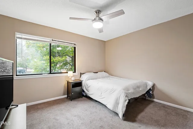a bed sitting in a room next to a window