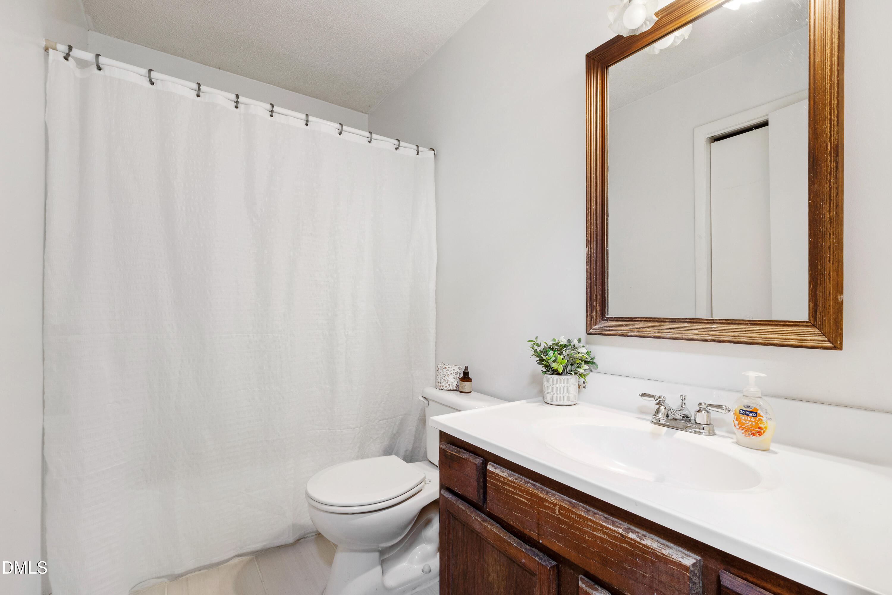5810 Shady Grove Circle Raleigh, NC 27609 - Photo 8 of 21 a bathroom with a sink and a mirror