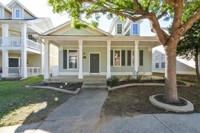 a front view of a house with garden and plants