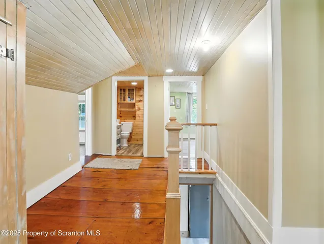 a view of a room with wooden floor and staircase