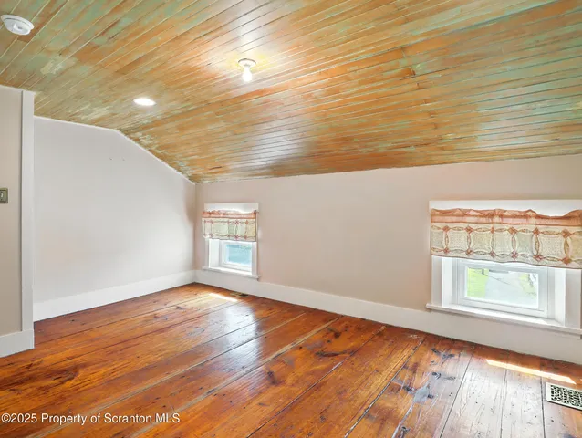 a view of an empty room and a window