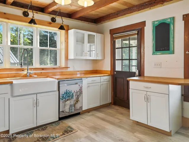 a kitchen that has a lot of windows in it