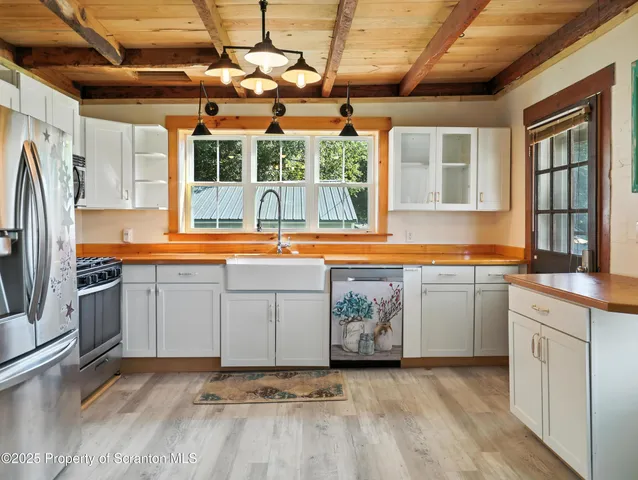 a kitchen with stainless steel appliances granite countertop a sink and a stove