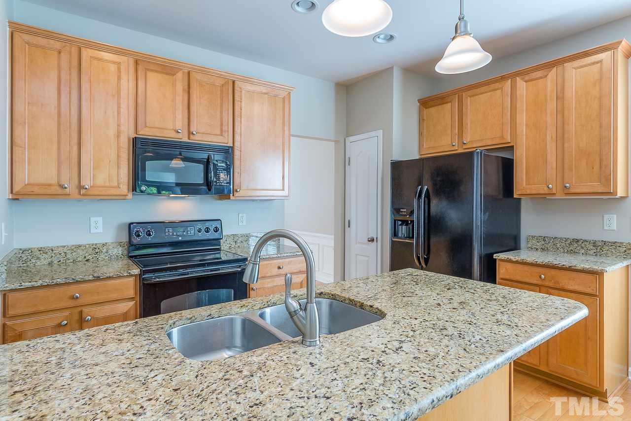 3601 Cathedral Bell Road Raleigh, NC 27614 - Photo 11 of 25 a kitchen with stainless steel appliances granite countertop a sink refrigerator stove and microwave