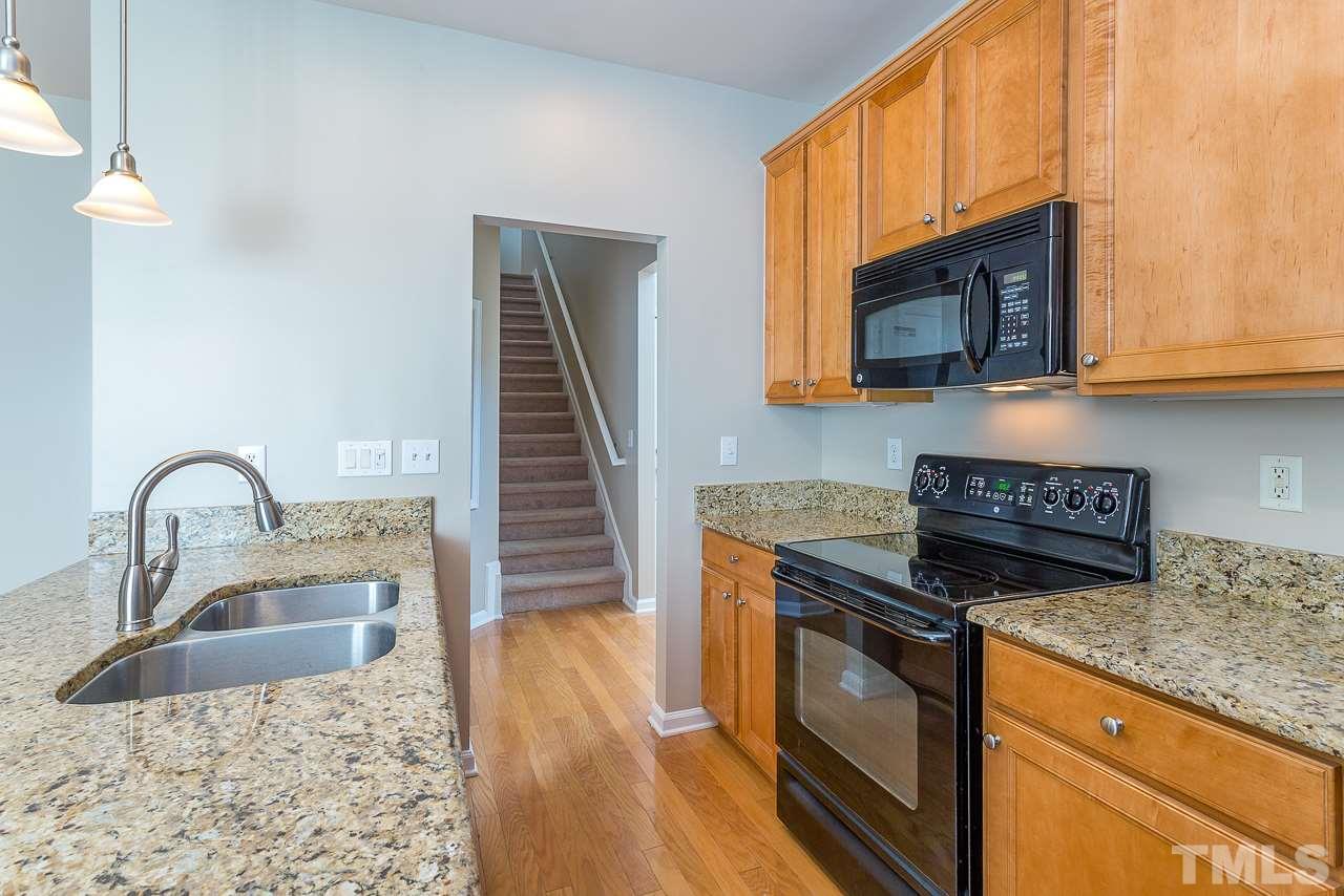 3601 Cathedral Bell Road Raleigh, NC 27614 - Photo 13 of 25 a kitchen with granite countertop a stove a sink and a microwave