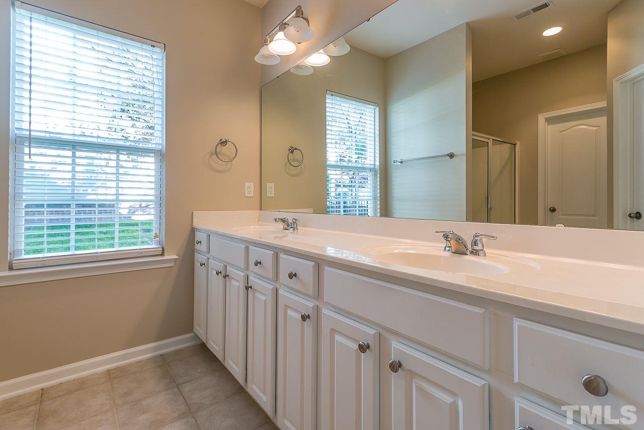 3601 Cathedral Bell Road Raleigh, NC 27614 - Photo 17 of 25 a bathroom with double sink large mirror and a window