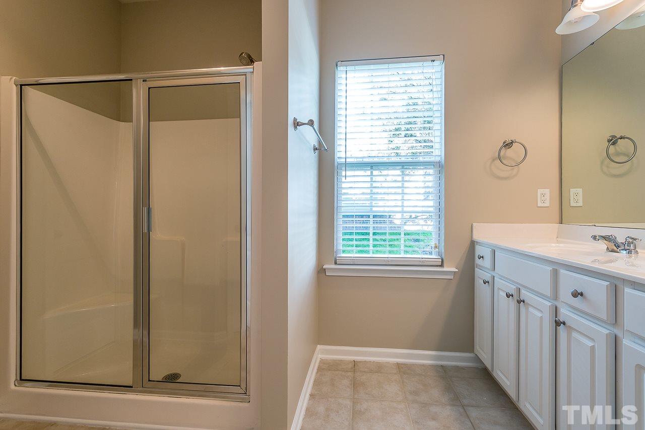 3601 Cathedral Bell Road Raleigh, NC 27614 - Photo 18 of 25 a bathroom with a shower sink and mirror