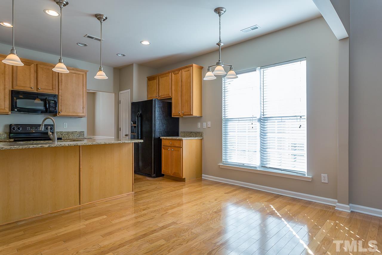 3601 Cathedral Bell Road Raleigh, NC 27614 - Photo 10 of 25 a large kitchen with stainless steel appliances granite countertop a stove a refrigerator and a large window