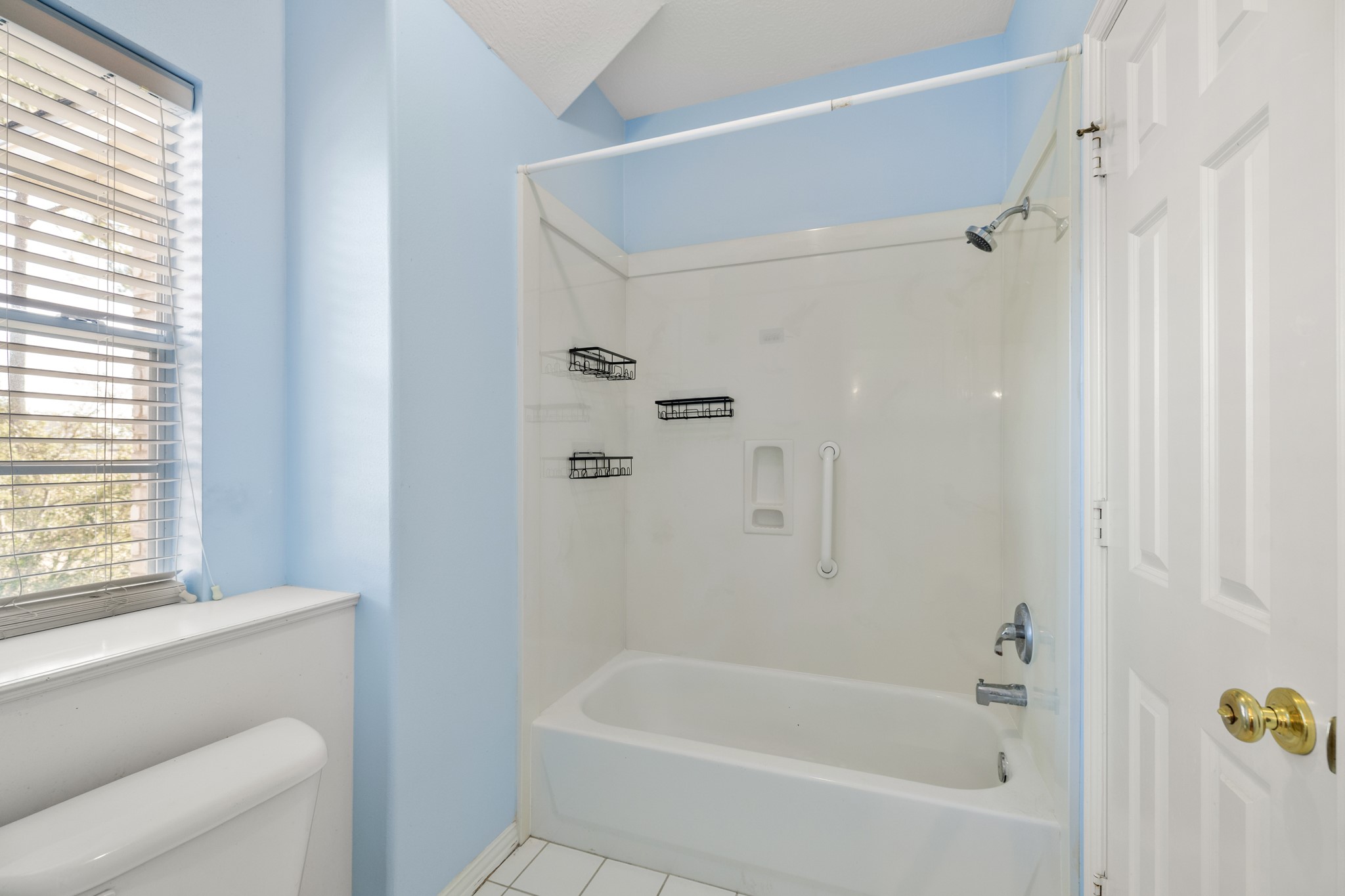 19315 Puget Lane Spring, TX 77388 - Photo 30 of 49 a bathroom with a bathtub a window and a shower
