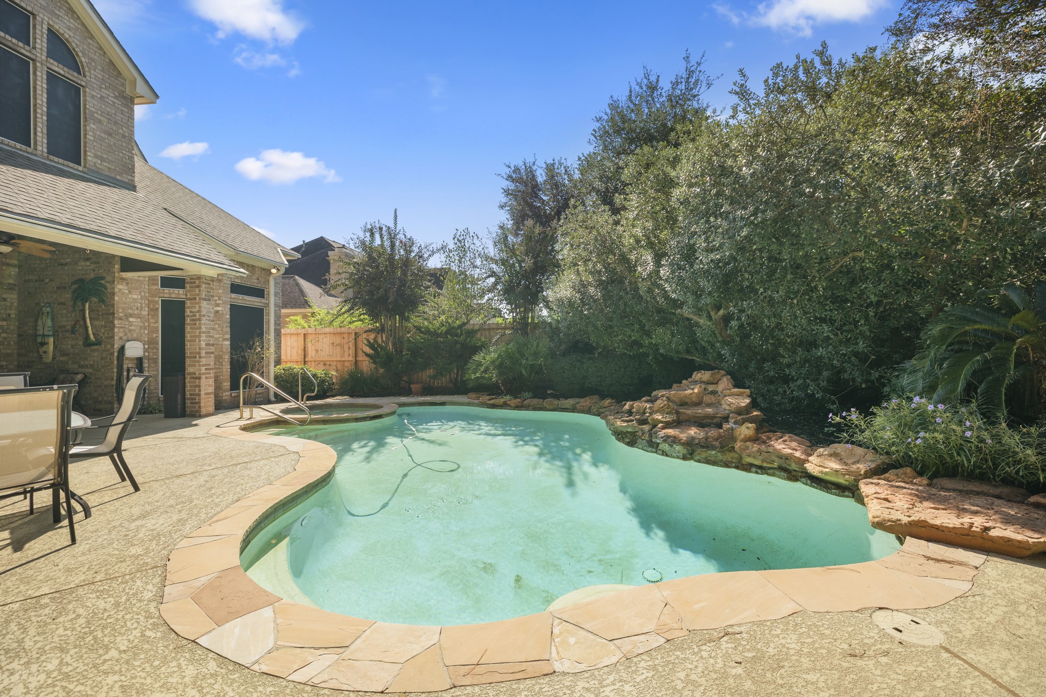 19315 Puget Lane Spring, TX 77388 - Photo 41 of 49 a view of a swimming pool with lawn chairs and plants