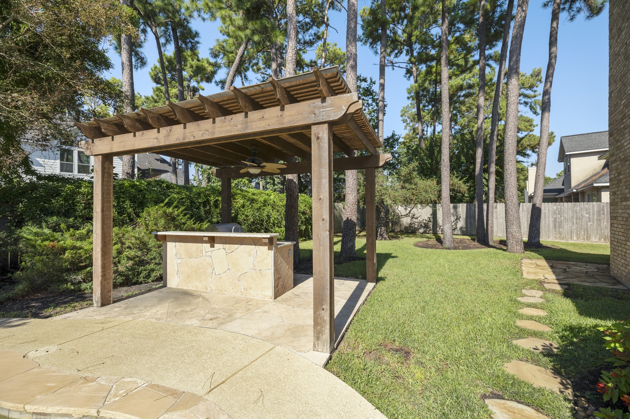 19315 Puget Lane Spring, TX 77388 - Photo 43 of 49 a view of a patio with table and chairs under an umbrella with large trees