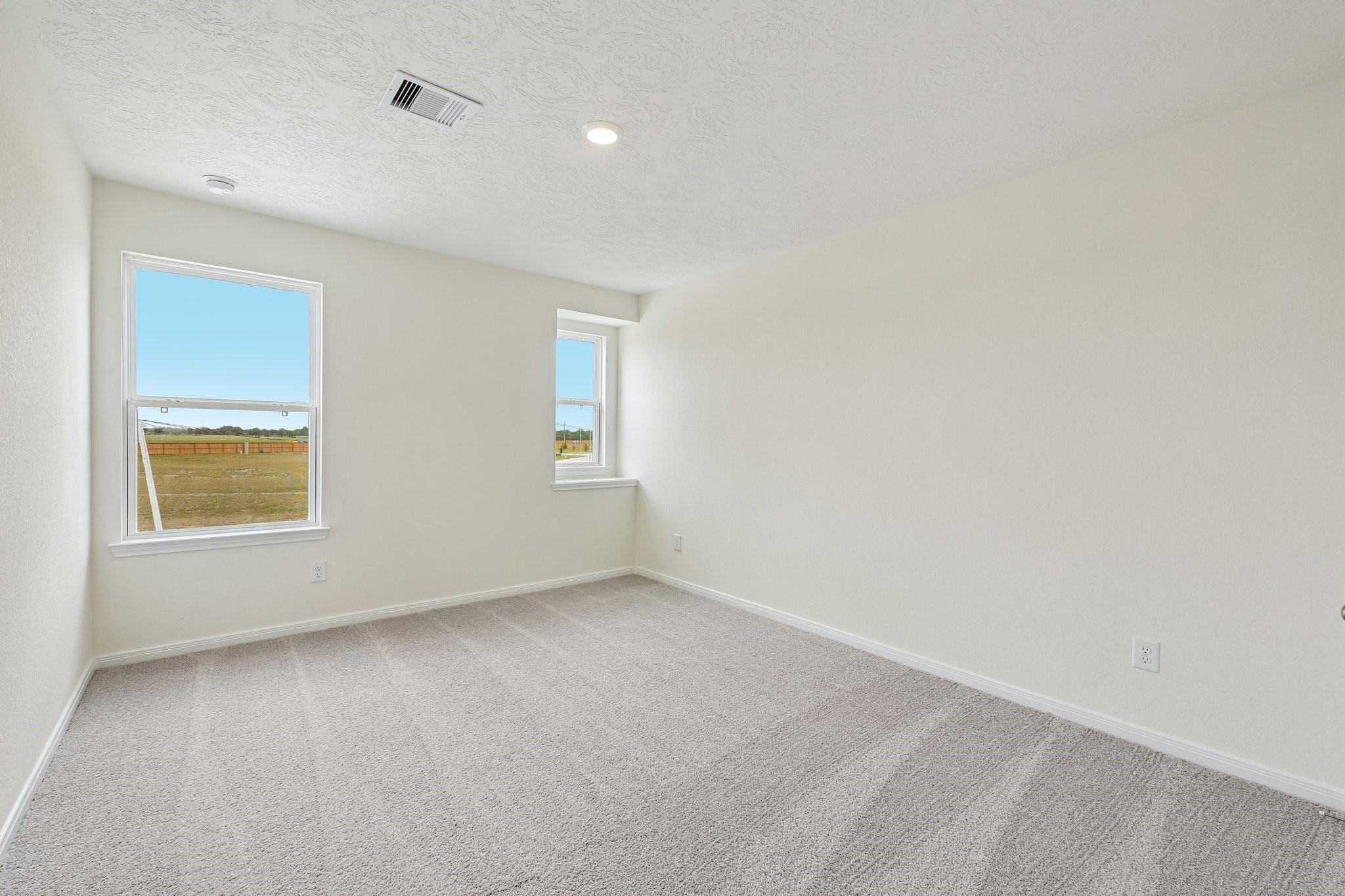 2503 Spruce Hl Road Beasley, TX 77417 - Photo 16 of 25 Well appointed secondary bedroom that features plush carpeting, neutral paint tones, recessed lighting, large window, and a generously sized closet.