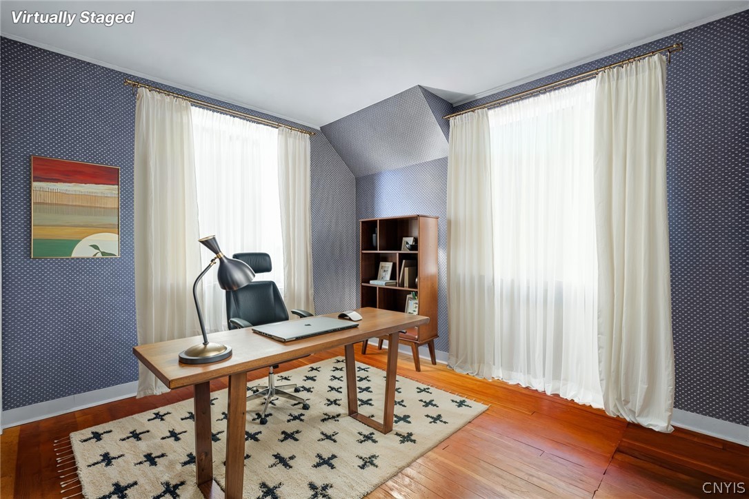7779 Bell Road North Rome, NY 13440 - Photo 29 of 38 Rich hardwood flooring complements patterned walls and tall windows in this tranquil workspace.