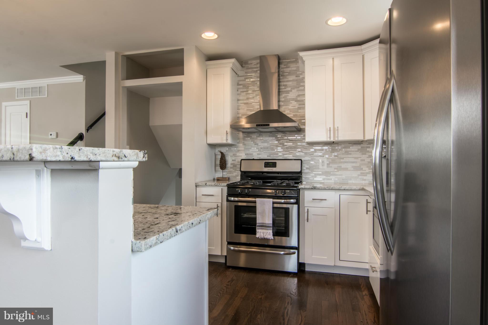 922 Bardswell Road Catonsville, MD 21228 - Photo 8 of 30 a kitchen with stainless steel appliances granite countertop a stove a refrigerator and a sink