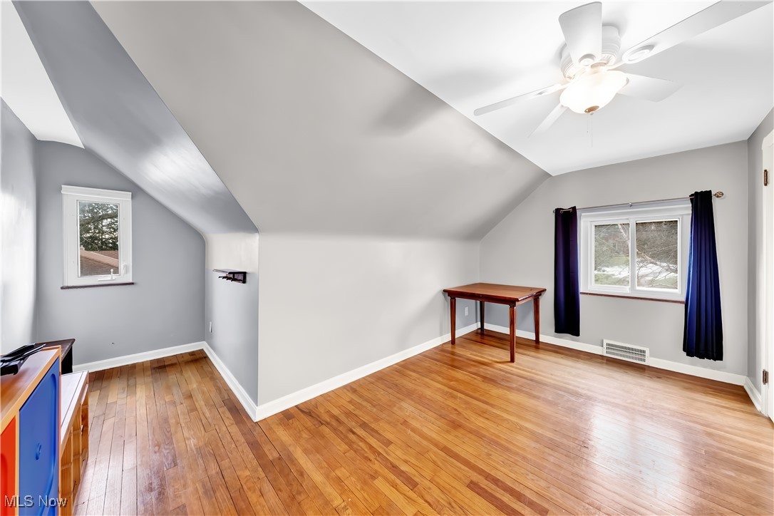 1051 Rockside Road Independence, OH 44131 - Photo 19 of 30 Additional living space featuring baseboards, visible vents, a ceiling fan, light wood-style flooring, and vaulted ceiling