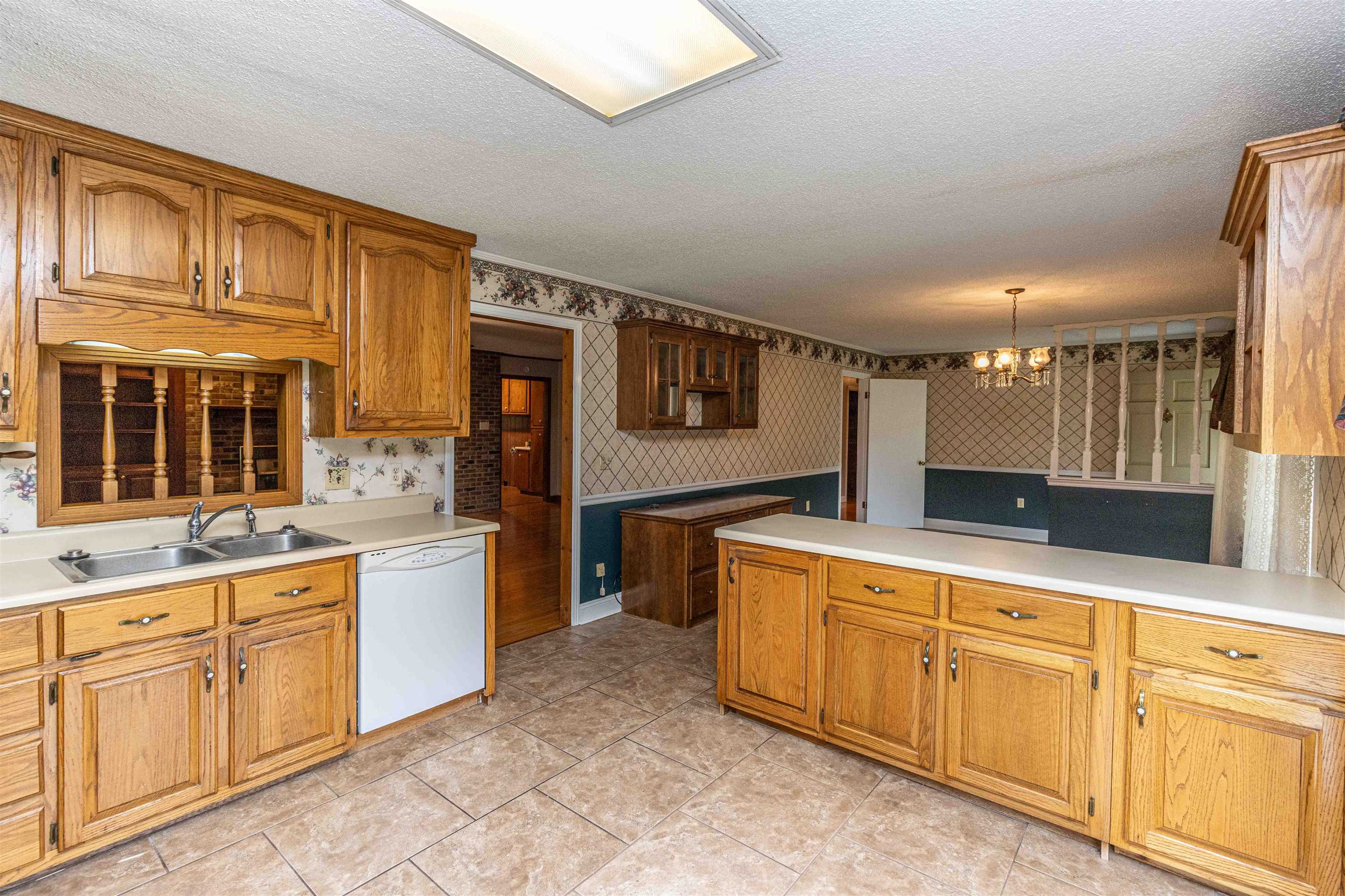 239 Old Road South, Unit 5 Selmer, TN 38375 - Photo 11 of 34 a large kitchen with stainless steel appliances granite countertop a sink and cabinets