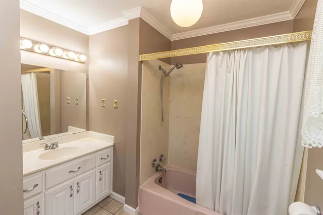 a bathroom with a granite countertop sink a mirror a shower and a bathtub