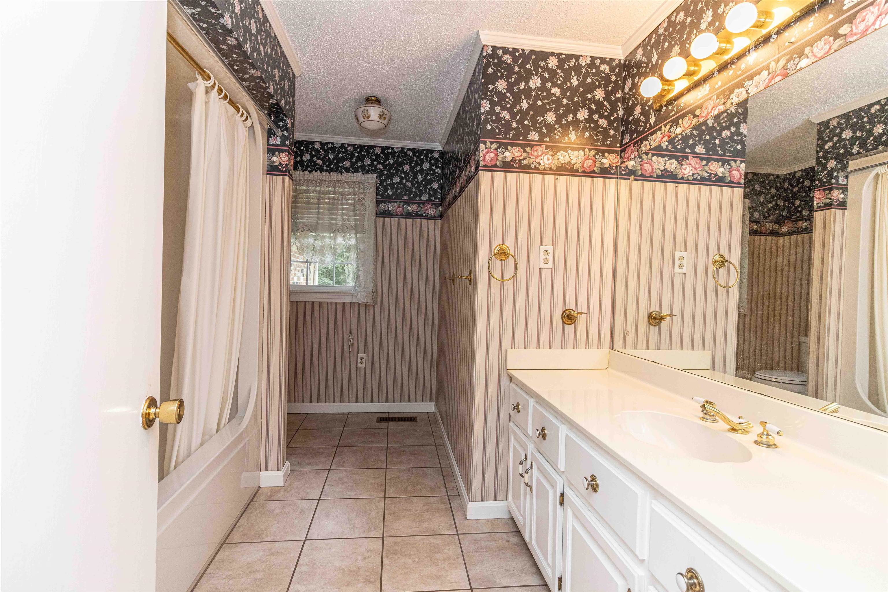 239 Old Road South, Unit 5 Selmer, TN 38375 - Photo 20 of 34 a bathroom with a double vanity sink and a bathtub
